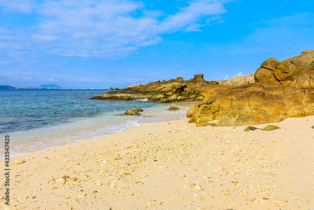 Landscape with beach,the sea and the beautiful clouds in the blue sky.rocks on the beach. Landscape with beach,the sea and the beautiful clouds in the blue sky.rocks on the beach.