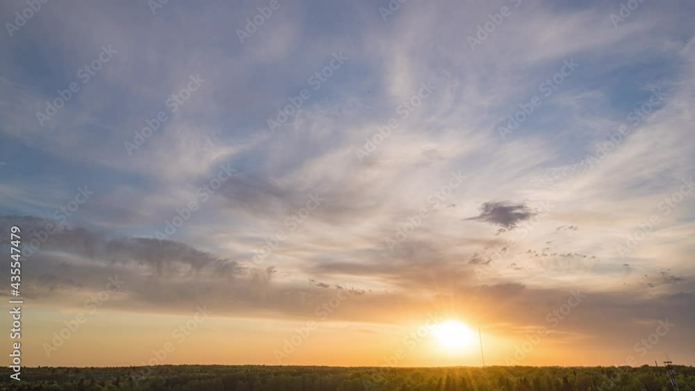 Beautiful evening sunset, time lapse, movement of clouds of a different level against the setting sun Beautiful evening sunset, time lapse, movement of clouds of a different level against the setting sun