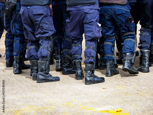 Riot police practice shields and baton