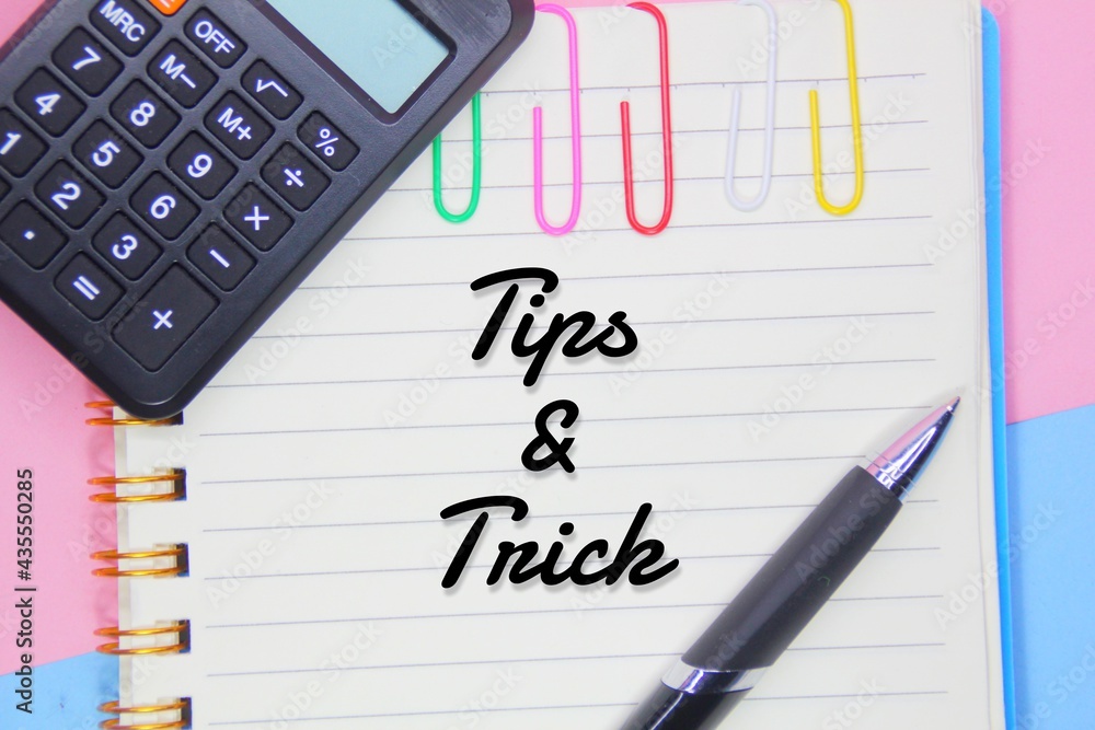 concept with Tips and Tricks with calculator, book and pen concept with Tips and Tricks with calculator, book and pen