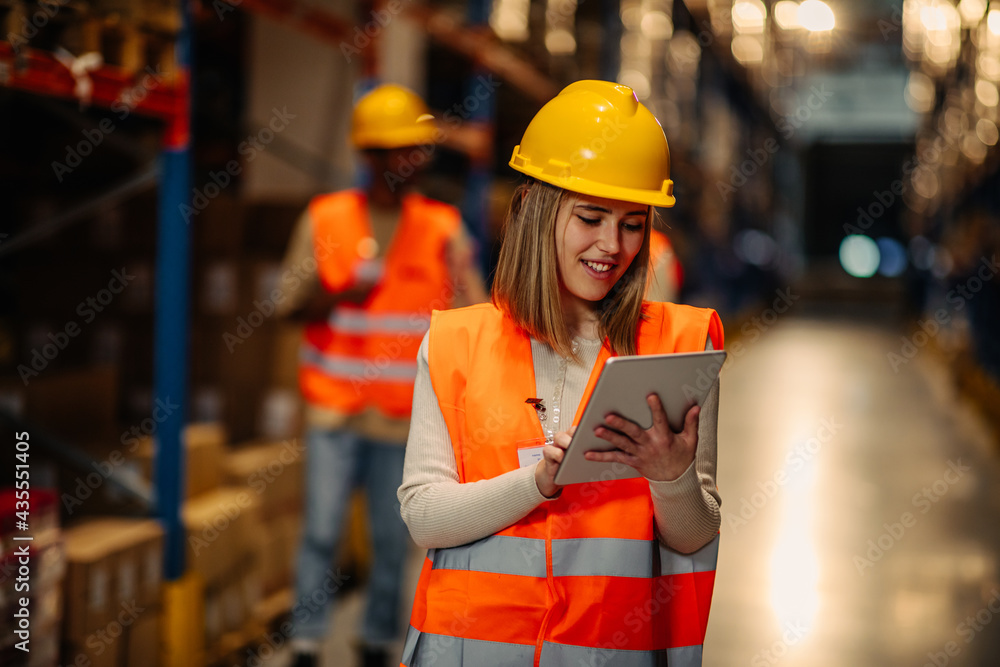 Warehouse worker checking stock levels Warehouse worker checking stock levels