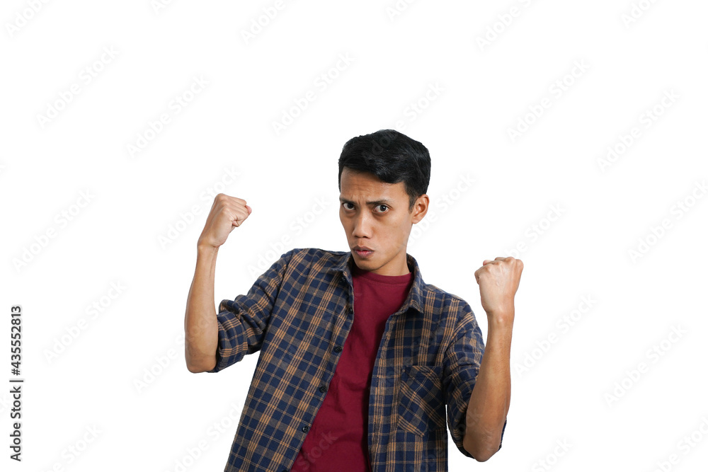 Asian man in casual clothes holding hands and cheering happily Asian man in casual clothes holding hands and cheering happily