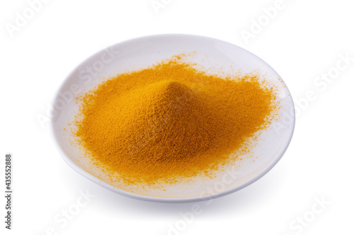 Dry Turmeric Organic Herbal or Turmeric Powder spice pile in a white bowl isolated on white background.