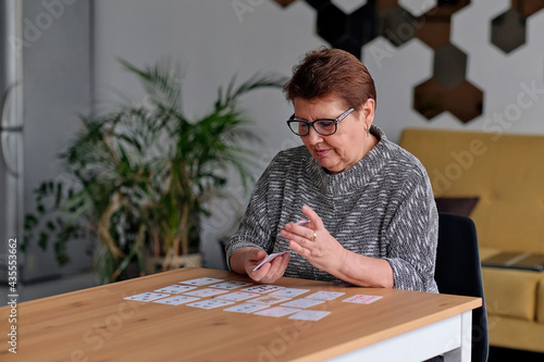 Close up of female holding cards and playing solitaire