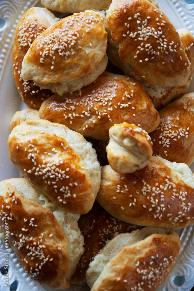 homemade pastry with sesame seeds and cheese inside from traditional Turkish cuisine. Front view.