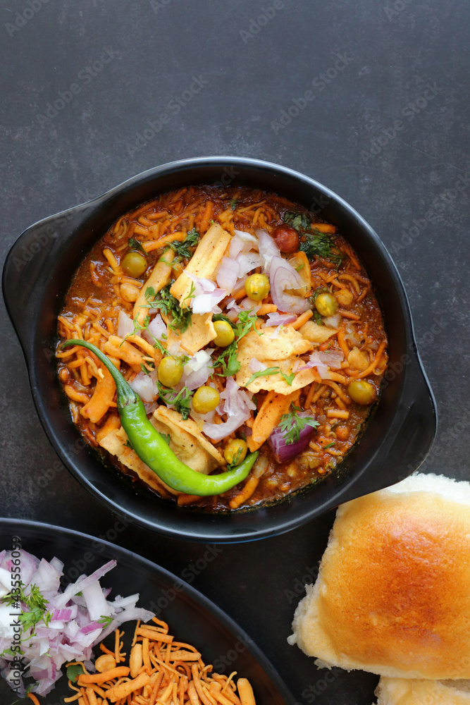 Spicy Misal Pav or usal Pav is a traditional snack or Chaat food from Maharashtra, India. Served with chopped onion, lemon wedges and farsan. Selective focus with copy space Spicy Misal Pav or usal Pav is a traditional snack or Chaat food from Maharashtra, India. Served with chopped onion, lemon wedges and farsan. Selective focus with copy space