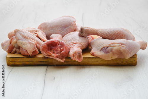 Variety of fresh chicken meat on cutting board
