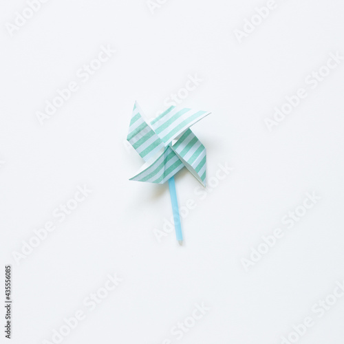 Green stripe pattern paper pinwheel isolated on white background. top view