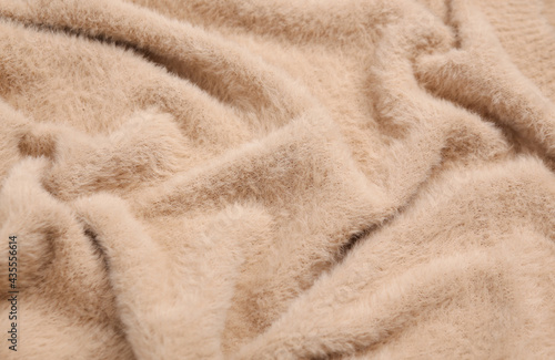 Soft beige fabric texture of sweater close up