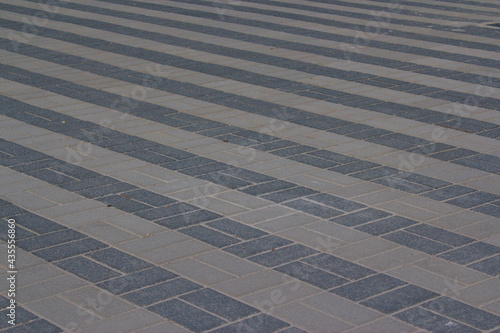 diagonal lines of pavement tails on square with perspective 