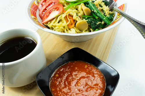 Indonesian Mie Goreng or Fried Noodle with egg traditional Indonesian or Chinese food with mustard greens