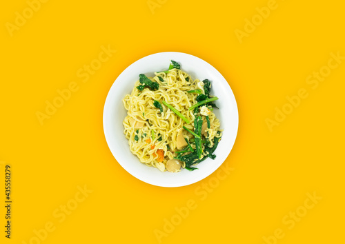 Indonesian Mie Goreng Nyemek or Fried Noodle with egg traditional Indonesian or Chinese food with mustard greens photo