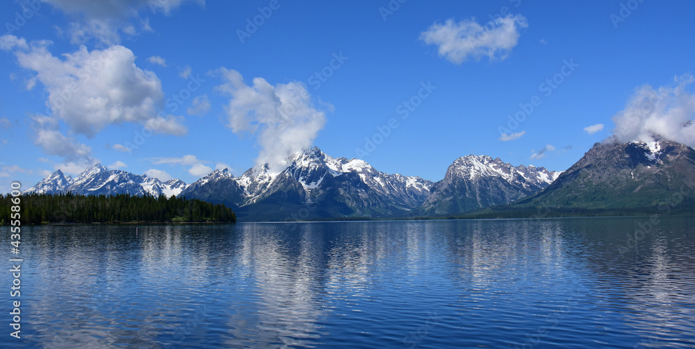 the incredible view of the grand teton range from the colter bay swimming beach  on a sunny summer day in grand teton national park, wyoming