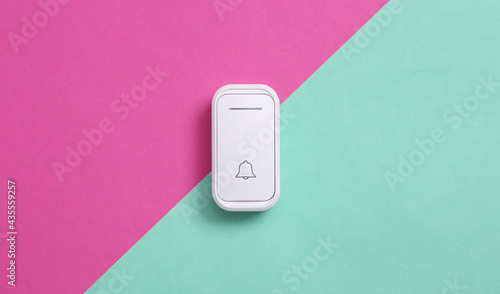 Doorbell on a blue pink background. Minimalism
