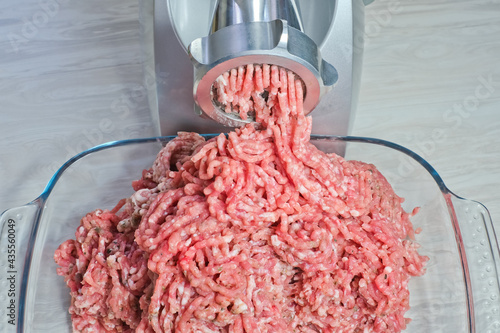 top view of freshly ground pork minced in an electric meat grinder