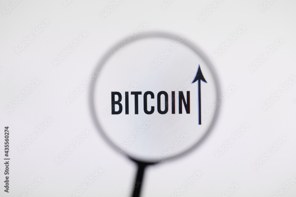 Bitcoin with a growth arrow on the monitor screen through magnifying glass Bitcoin with a growth arrow on the monitor screen through magnifying glass