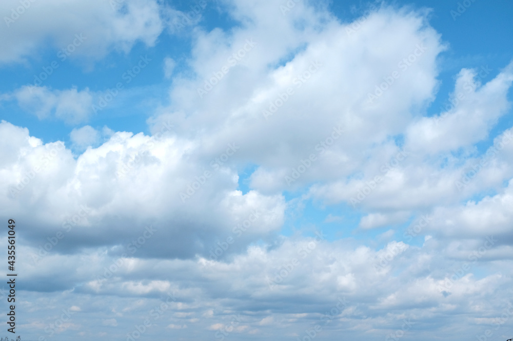 Big white clouds on a blue sky in clear weather