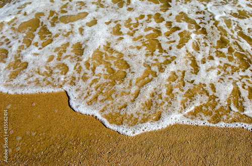 The waves hit the beach in the evening