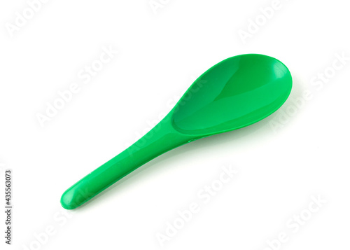 Green color of plastic spatula isolated on white background.