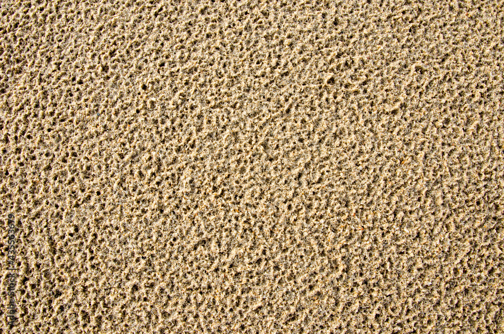 Image of the surface of the sand after rain has porous rain marks
Image of the surface of the sand after rain has porous rain marks