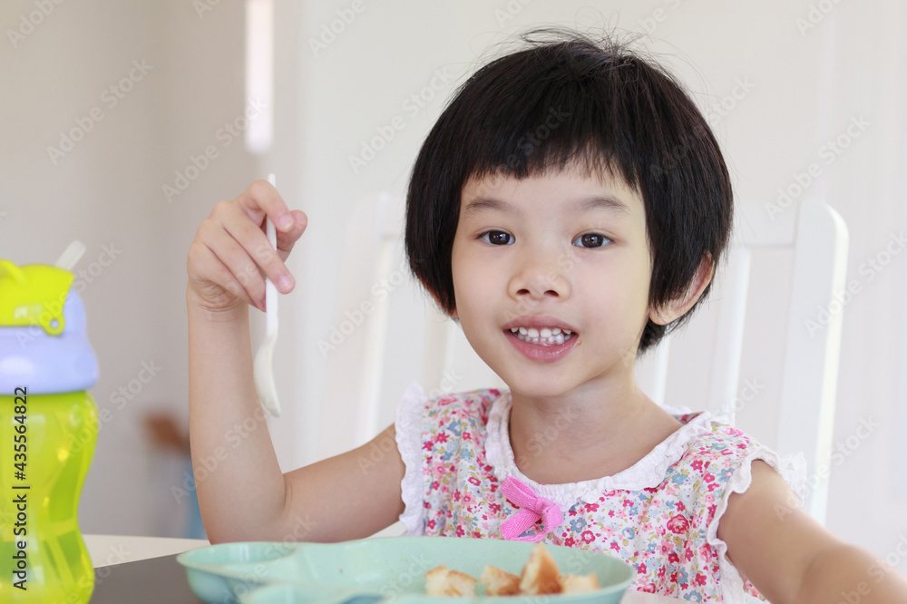 Little asian girl having breakfast Little asian girl having breakfast
