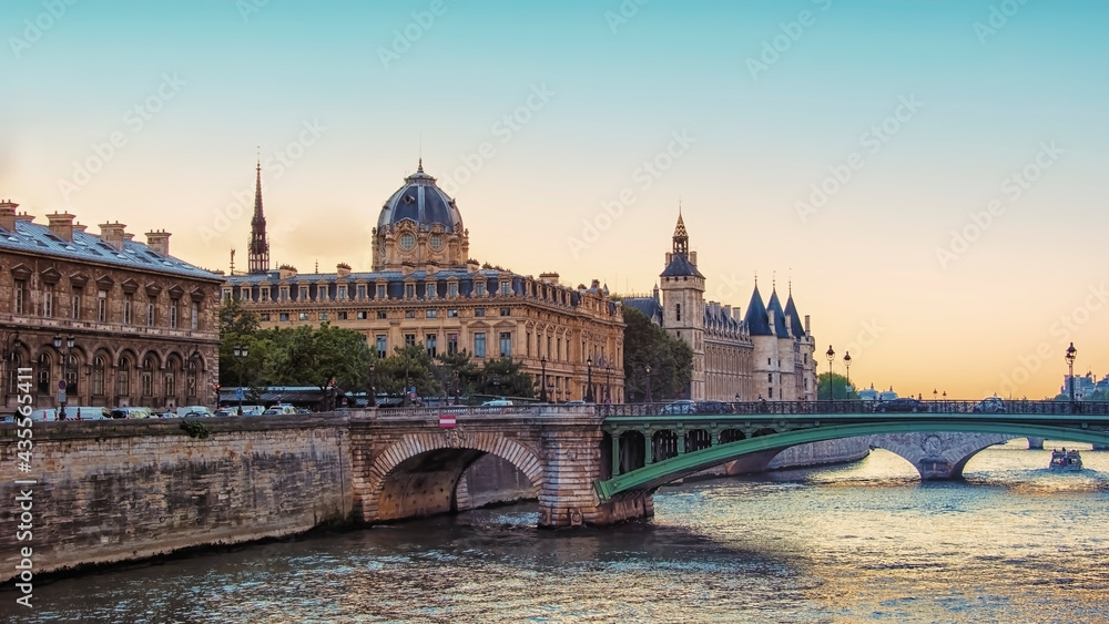 Conciergerie and Seine river in Paris at sunset