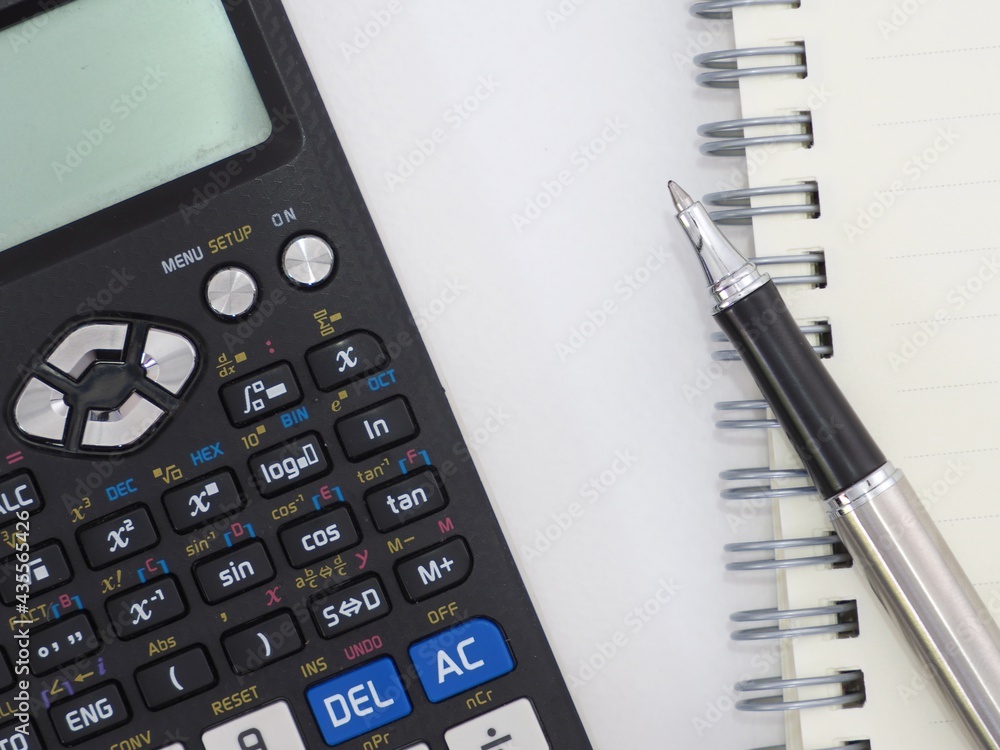 Scientific calculator pen and notepad on white background picture. Scientific calculator pen and notepad on white background picture.