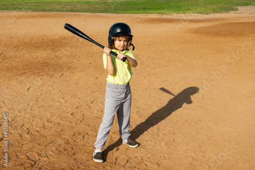 Child batter about to hit a pitch during a baseball game. Kid baseball ready to bat.