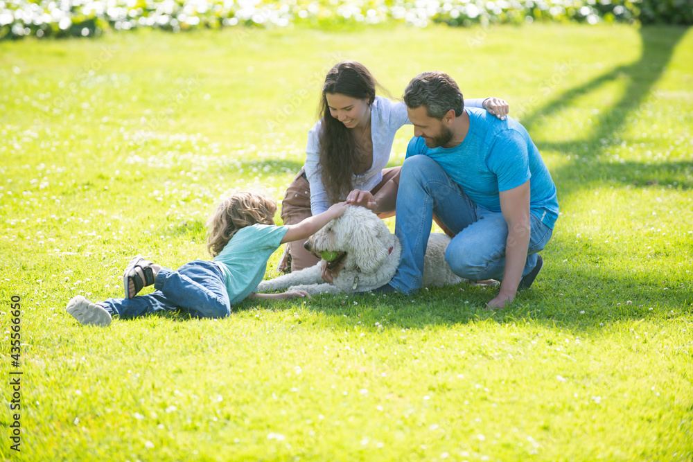 Portrait of a happy smiling family with pet dog relaxing in park. Portrait of a happy smiling family with pet dog relaxing in park.