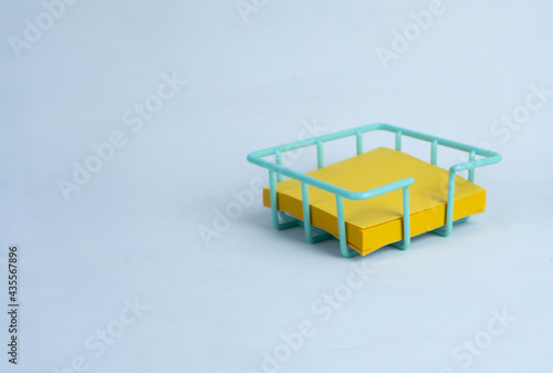 empty yellow sticky note in basket isolated on white background