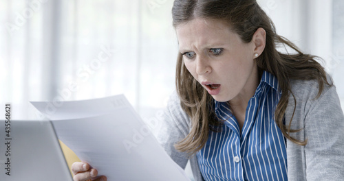 Disappointed woman reading a rejection letter photo
