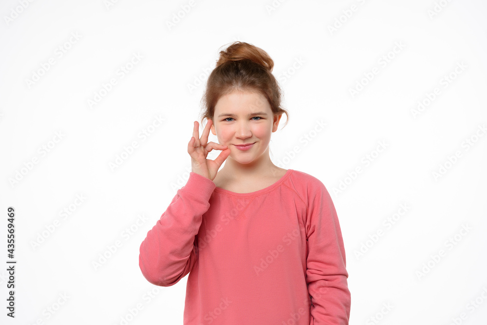 Your secrets safe with me concept. Young girl showing zip gesture as if shutting mouth on key Your secrets safe with me concept. Young girl showing zip gesture as if shutting mouth on key