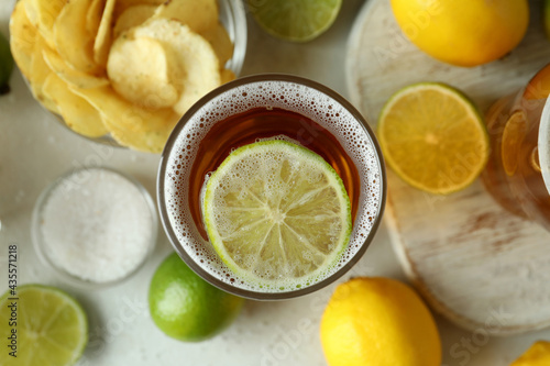 Glass of beer with lime slice, close up and top view