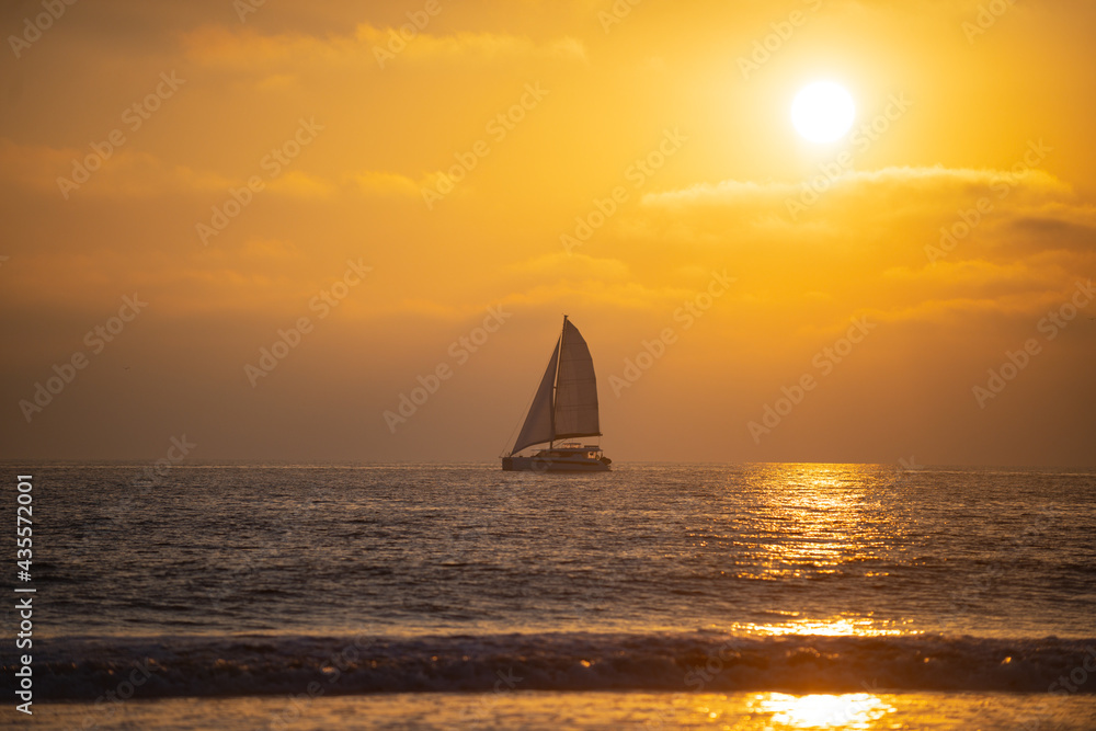 Sailboat at sea. Tropical beach sea ocean with sunset or sunrise for summer travel vacation. Ocean seascape.