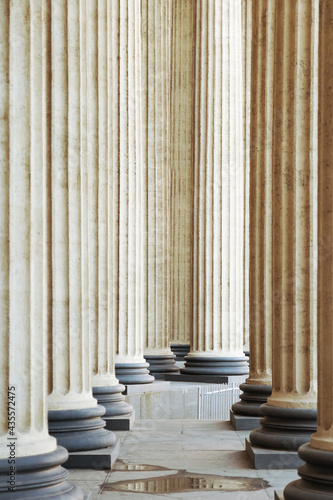 High marble columns as background, architectural design in style of classicism. Architectural pattern