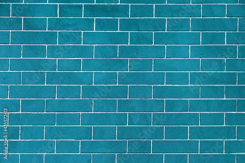 Brick wall is bright blue colored, texture of stone blocks, background of bricks.