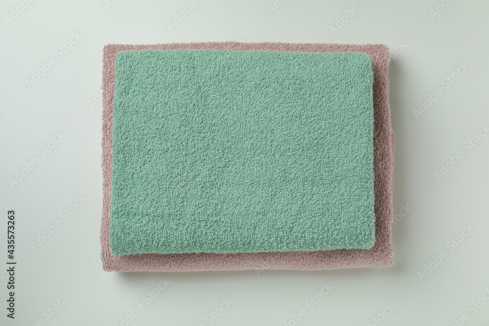 Fototapeta premium Clean folded towels on light gray background, top view