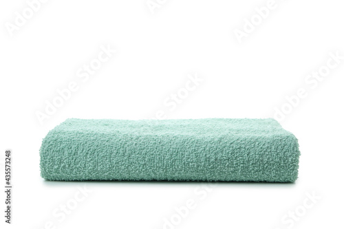 Green folded towel isolated on white background