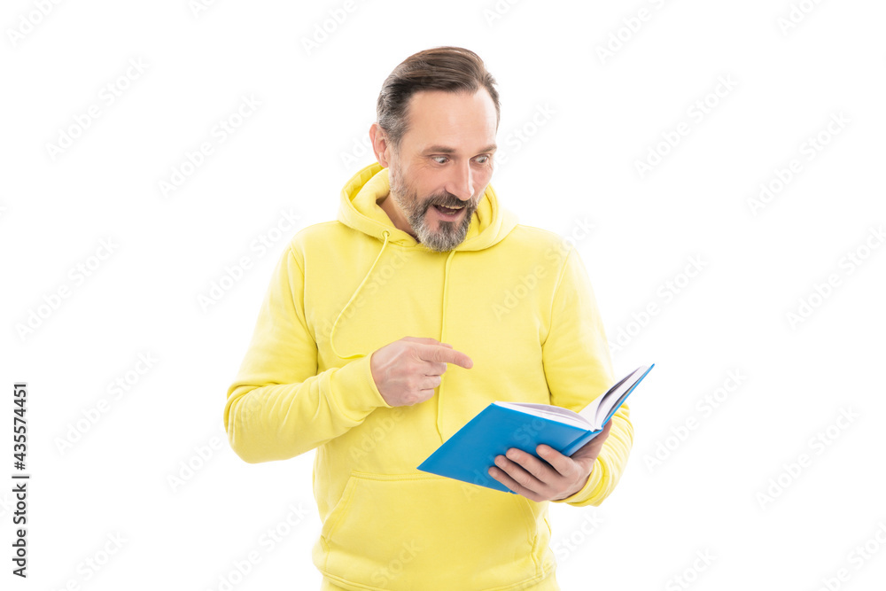 caucasian man in yellow hoody planning his work. adult guy reading planner. agenda. caucasian man in yellow hoody planning his work. adult guy reading planner. agenda.
