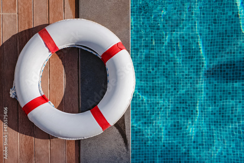 Top view of lifebuoy lying near the swimming pool photo