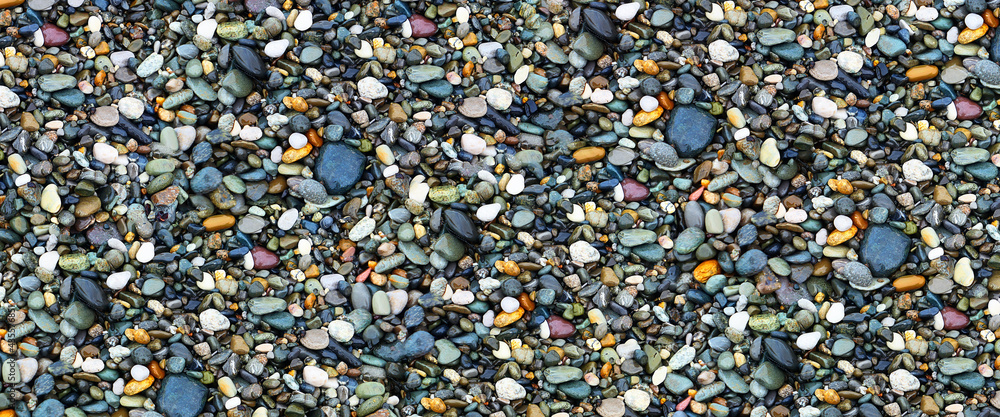 Wet round stones on sea coast