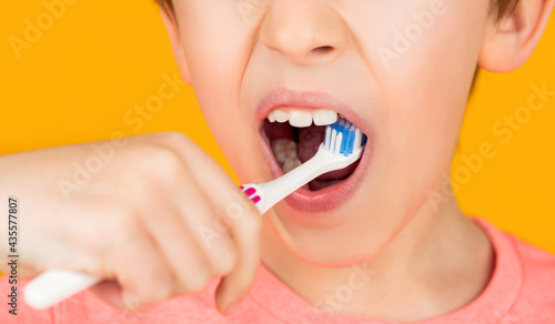 Little boy cleaning teeth with kids toothbrush. Dental hygiene. Little man brushing teeth. Happy child kid boy with toothbrush. Health care  dental hygiene