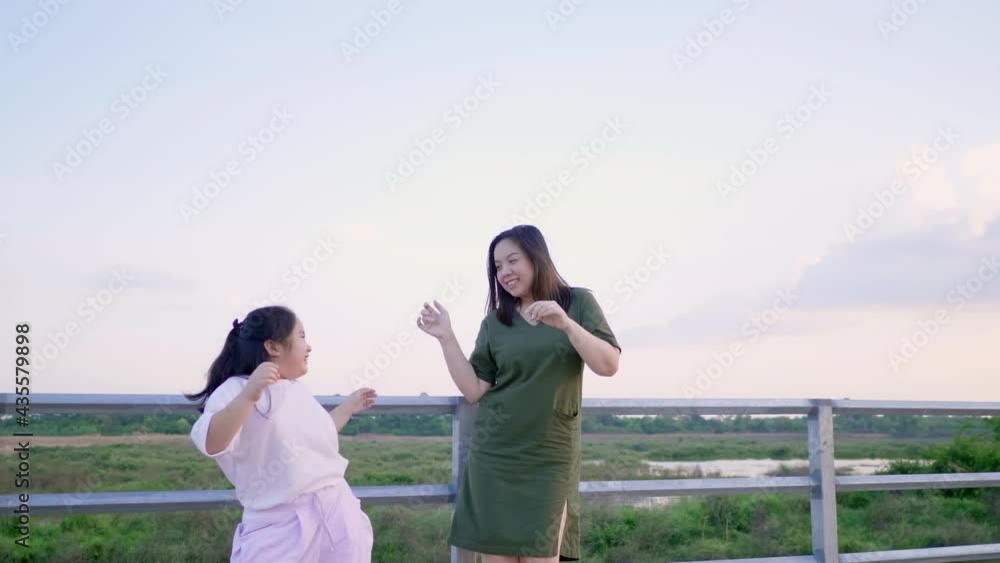 Asian mom and kid are on vacation. Spending time outdoor and dancing together. Happy and having fun. lovely family concept. Asian mom and kid with beautiful nature Asian mom and kid are on vacation. Spending time outdoor and dancing together. Happy and having fun. lovely family concept. Asian mom and kid with beautiful nature