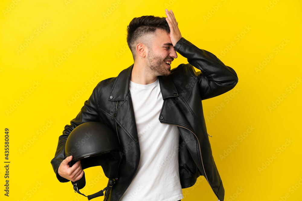 Young caucasian man with a motorcycle helmet isolated on yellow background has realized something and intending the solution Young caucasian man with a motorcycle helmet isolated on yellow background has realized something and intending the solution