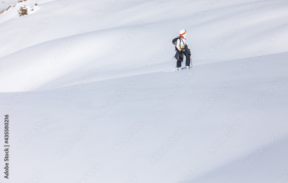 Skier walks on fresh snow uphill Skier walks on fresh snow uphill