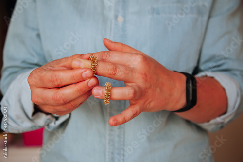Person holding Sujok rings for fingers. Sujok acupressure therapy concept. Physical Therapy and massage items concept. 