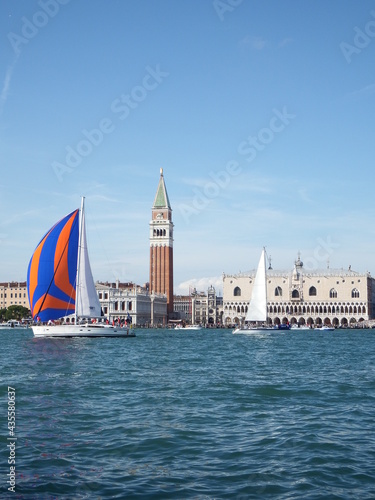 The Dogenpalace and Church of San Marco at the Venetian Lagoon from an Outstanding View with sail boats on a Sunny Day in Italy