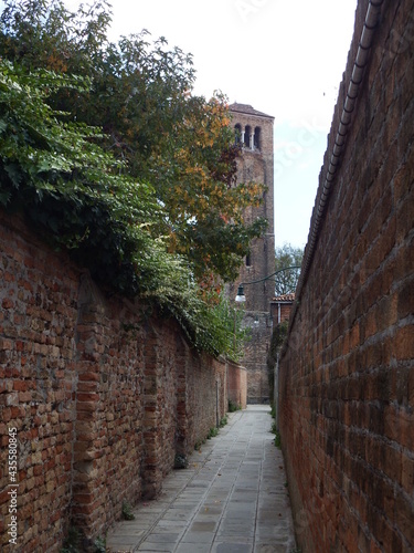 A Beautiful Narrow Italien Street with Brick Walls and Trees in Venice´s Murano