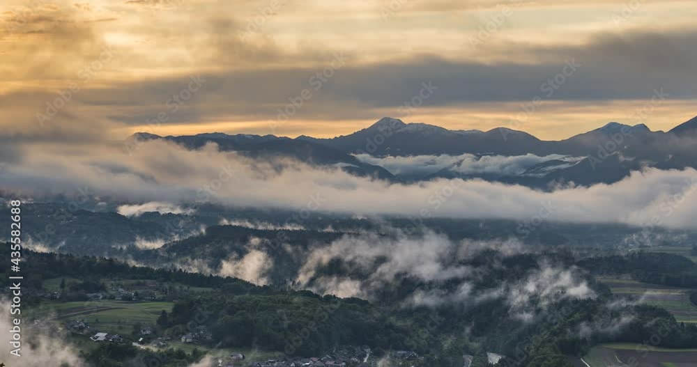 Dramatic and colorful time lapse. Vibrant sunset in Slovenia. Elevated view of mountains. Golden hour over the Alps. Fog moving and evaporating in the valley. Left trucking, wide angle Dramatic and colorful time lapse. Vibrant sunset in Slovenia. Elevated view of mountains. Golden hour over the Alps. Fog moving and evaporating in the valley. Left trucking, wide angle