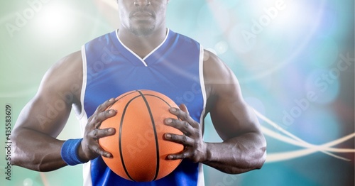 Composition of midsection of basketball player holding ball with copy space